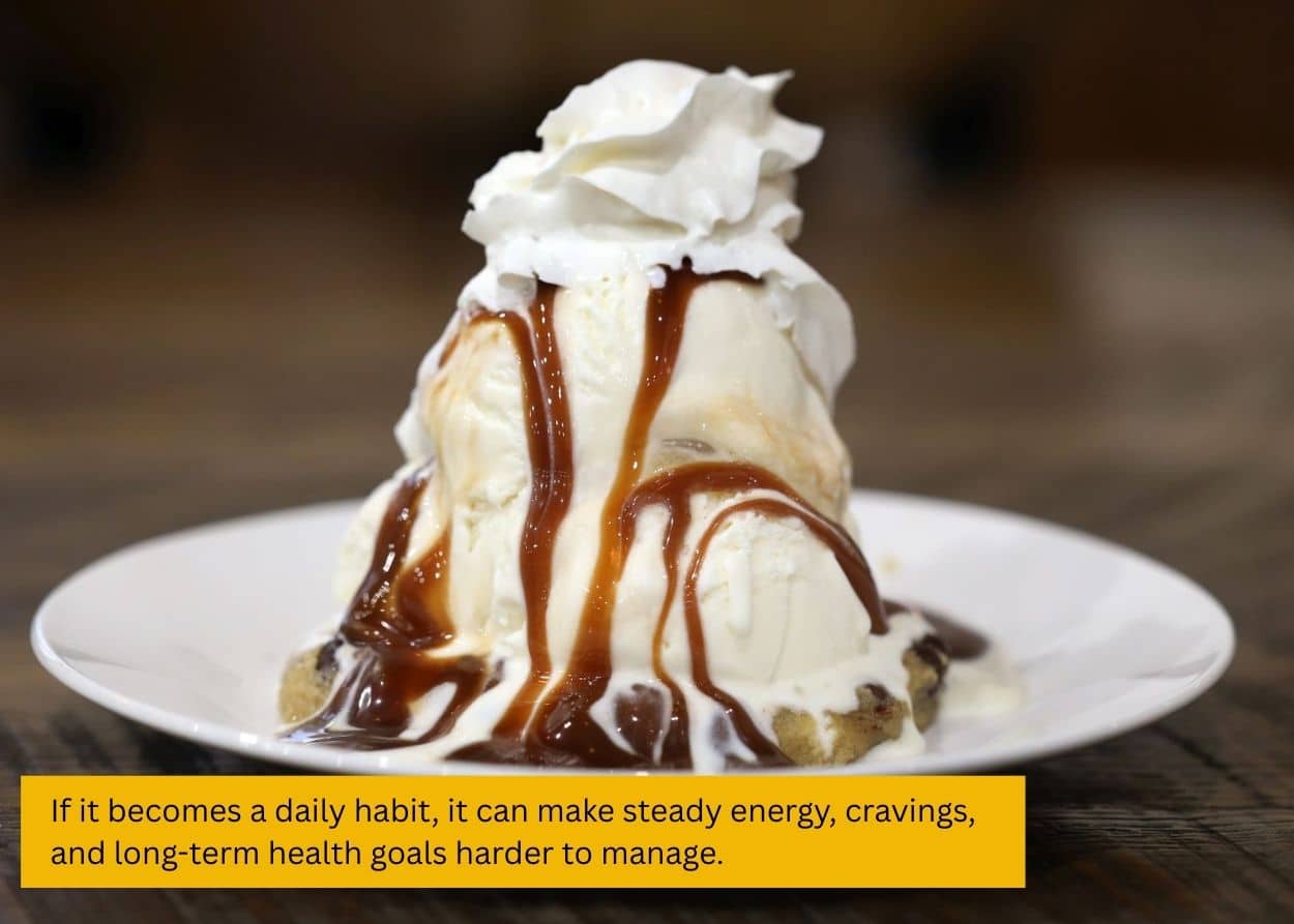 Vanilla ice cream dessert topped with chocolate sauce and whipped cream. Caption: If it becomes a daily habit, it can make steady energy, cravings, and long-term health goals harder to manage.